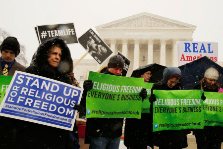 Protesters pray at the steps of the Supreme Court as arguments begin today to challenge the Affordable Care Act's requirement that employers provide coverage for contraception as part of an employee's health care, in Washington March 25, 2014. The U.S. Supreme Court convened on Tuesday to consider whether business owners can object on religious grounds to a provision of President Barack Obama's healthcare law requiring employers to provide health insurance that covers birth control.