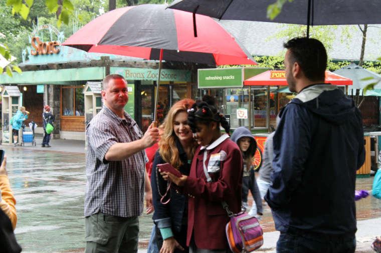 Victoria Osteen checks the smartphone of a young student after posing with her for a selfie, during her visit on Thursday, June 5, 2014, to the Bronx Zoo in the Bronx borough of New York City, as part of Joel Osteen Miniseries's Generation Hope Project outreach.