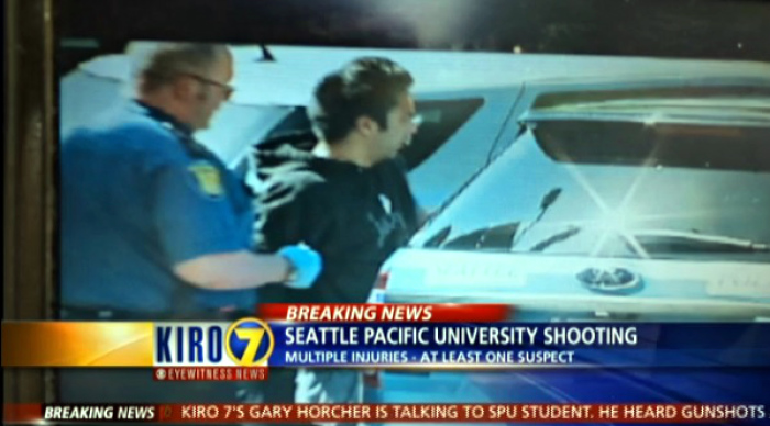 A suspect is placed in a police cruiser Thursday, June 5, 2014, after reports of several people being shot on the campus of Seattle Pacific University in Washington.