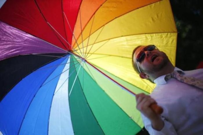 Members of the London Gay Men's Choir perform in front of the Houses of Parliament in central London, England, July 15, 2013.