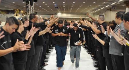 Church members at Igreja Apostolica Plenitude Do Trono De Deu in Sao Paulo, Brazil march over anointed salt during a church service.