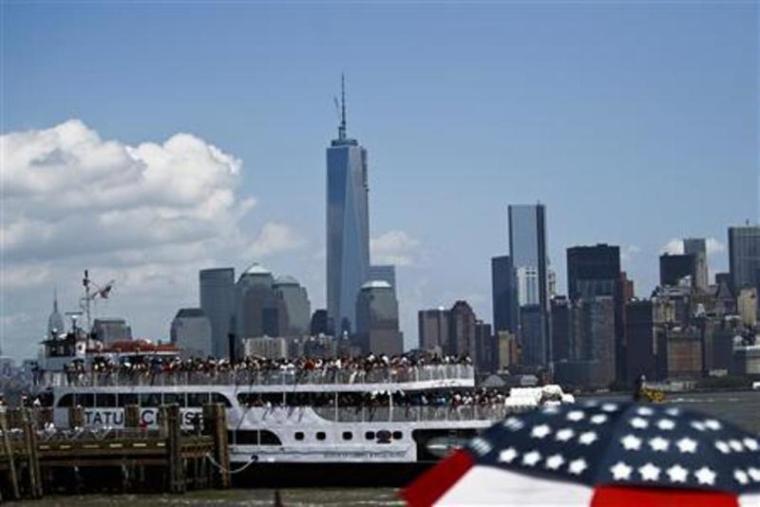 People arrive from lower Manhattan to the Statue of Liberty during its reopening to the public in New York July 4, 2013. Under steamy summer skies, tourists in New York flocked to ferries headed for the Statue of Liberty, re-opening with an Independence Day ceremony after closing in October as Superstorm Sandy approached.