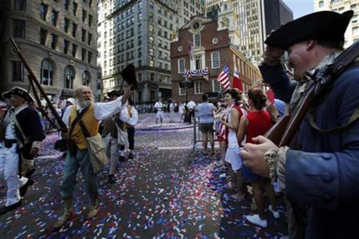 Re-enactors march away from the Old State House following a public reading of the United States Declaration of Independence, part of July Fourth Independence Day celebrations, in Boston, Massachusetts, July 4, 2013.