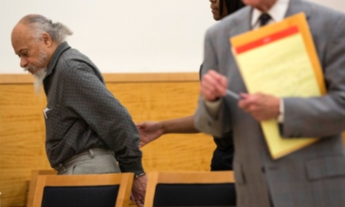 The defendant is led away by a court officer following his sentencing in Kings County supreme court.