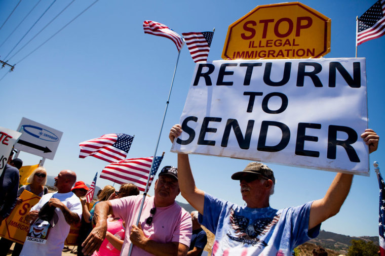 Demonstrators picket against the possible arrivals of undocumented migrants who may be processed at the Murrieta Border Patrol Station in Murrieta, California July 1, 2014. Some 140 undocumented immigrants, many of them women with children, will be flown from Texas to California and processed through a San Diego-area U.S. Border Patrol station as federal officials deal with a crush of Central American migrants at the border, a local mayor said on Monday.