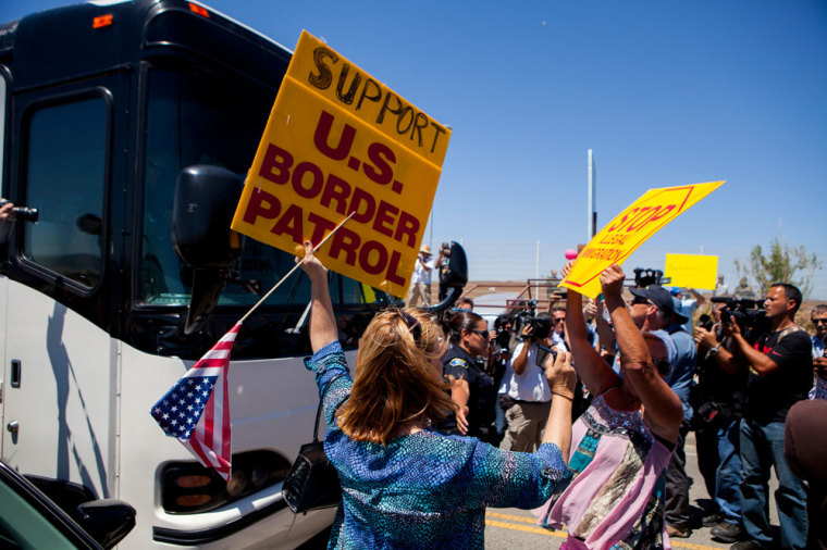 Demonstrators picketing against the arrival of undocumented migrants who were scheduled to be processed at the Murrieta Border Patrol Station block the buses carrying the migrants in Murrieta, California July 1, 2014. Some 140 undocumented immigrants, many of them women with children, will be flown from Texas to California and processed through a San Diego-area U.S. Border Patrol station as federal officials deal with a crush of Central American migrants at the border, a local mayor said on Monday.