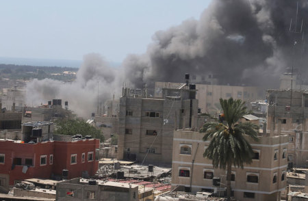 Smoke rises following what witnesses said was an Israeli air strike on a house in Rafah in the southern Gaza Strip July 14, 2014. Israel said it shot down a drone from Gaza a week into its offensive on Monday, the first reported deployment of an unmanned aircraft by Palestinian militants whose rocket attacks have been regularly intercepted.Al-Mezan, a Gaza-based Palestinian human rights group, said 869 Palestinian homes have been destroyed or damaged in Israeli attacks over the past week. More than 166 Palestinians, most of them civilians, have been killed, Gaza health officials said, in seven days of fighting that has shown no sign of ending. Israel says its offensive is intended to halt rocket fire at its cities from the Gaza Strip.