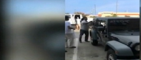 A crowd gathers to rescue two small children from a hot vehicle.