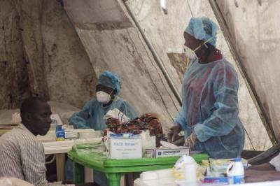 Health workers take blood samples for Ebola virus testing at a screening tent in the local government hospital in Kenema, Sierra Leone, June 30, 2014.