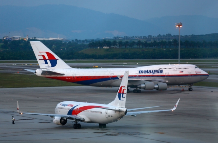 Malaysia Airlines aircrafts taxi on the runway at Kuala Lumpur International Airport in Sepang outside Kuala Lumpur May 13, 2014. Malaysia Airlines will report first-quarter earnings later on May 15, 2014, that are set to provide confirmation of just how badly the already loss-making carrier's finances have been hit by the vanishing of flight MH370 on March 8. Picture taken May 13, 2014.