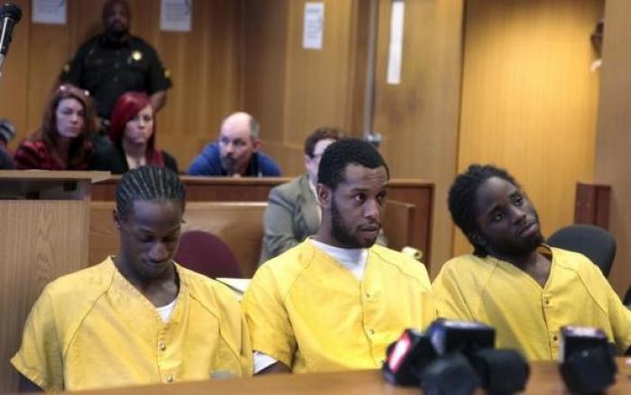 Family members of Steve Utash watch from the back of the courtroom during the preliminary examination of co-defendants Latrez Cummings (R), James Davis and Wonzy Saffold in the beating of motorist Steve Utash after he accidentally struck and injured a child with his truck in Detroit, Michigan April 21, 2014.