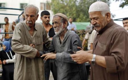 A wounded Palestinian man reacts after the death of his relatives, who medics said were killed during heavy Israeli shelling at the Shejaia district, at a hospital in Gaza City July 20, 2014.