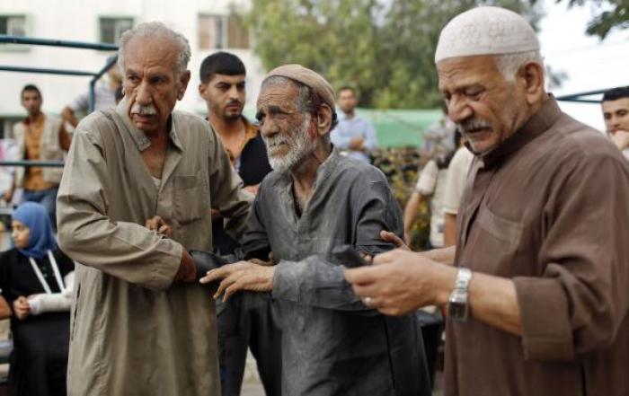 A wounded Palestinian man reacts after the death of his relatives, who medics said were killed during heavy Israeli shelling at the Shejaia district, at a hospital in Gaza City July 20, 2014.