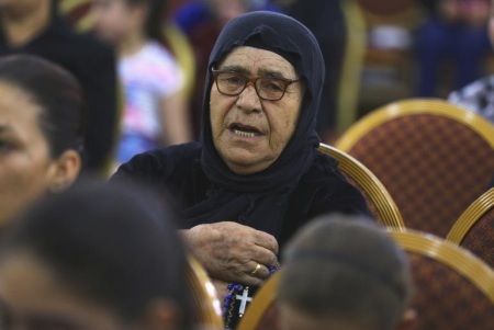 An Iraqi Christian woman fleeing the violence in the Iraqi city of Mosul, prays at the Mar Afram church at the town of Qaraqush in the province of Nineveh, July 19, 2014.