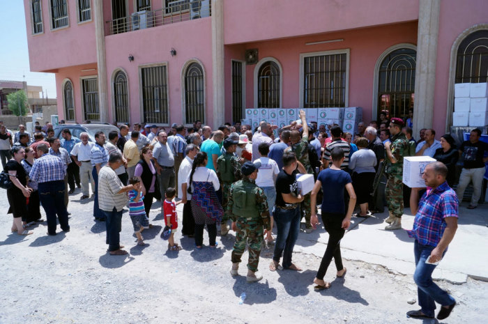 Displaced Christians wait for humanitarian aid at a church in Hamdaniya town, east of Mosul, northwest of Baghdad, July 20, 2014. The head of Iraq's largest church said on July 20, 2014 that Islamic State militants who drove Christians out of Mosul were worse than Mongol leader Genghis Khan and his grandson Hulagu who ransacked medieval Baghdad. Picture taken July 20, 2014.