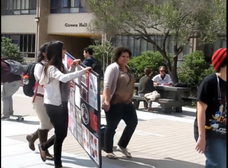 UC Santa Barbara professor of feminist studies, Mireille Miller-Young, removes and defaces a pro-life poster from campus on March 4, 2014.