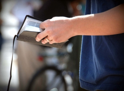 A man holds a Bible in this file photo.