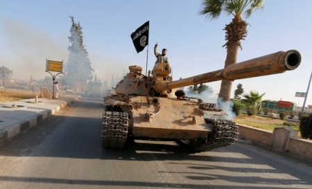 Militant Islamist fighters on a tank take part in a military parade along the streets of northern Raqqa province June 30, 2014. Militant Islamist fighters held a parade in Syria's northern Raqqa province to celebrate their declaration of an Islamic 'caliphate' after the group captured territory in neighbouring Iraq, a monitoring service said. The Islamic State, an al Qaeda offshoot previously known as Islamic State in Iraq and the Levant, posted pictures online on Sunday of people waving black flags from cars and holding guns in the air, the SITE monitoring service said.