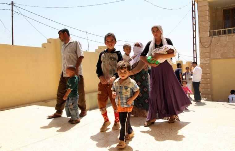 Displaced families from the minority Yazidi sect, fleeing the violence in the Iraqi town of Sinjarl west of Mosul, arrive at Dohuk province, August 4, 2014. Iraq's Prime Minister Nuri al-Maliki ordered his air force for the first time to back Kurdish forces against Islamic State fighters after the Sunni militants made another dramatic push through the north, state television reported on Monday.