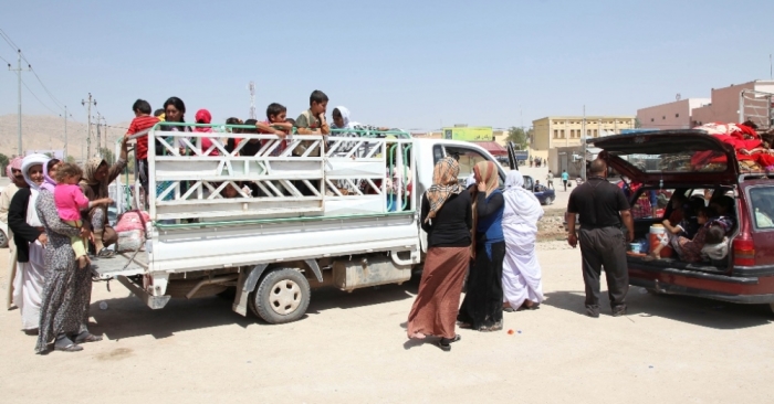 Displaced families from the minority Yazidi sect, fleeing the violence in the Iraqi town of Sinjarl west of Mosul, arrive at Dohuk province, August 4, 2014. Iraq's Prime Minister Nuri al-Maliki ordered his air force for the first time to back Kurdish forces against Islamic State fighters after the Sunni militants made another dramatic push through the north, state television reported on Monday