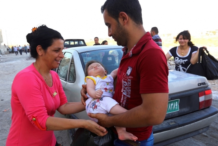 An Iraqi Christian family fleeing the violence in the Iraqi city of Mosul, arrives at the town of Qaraqush in the province of Nineveh, July 19, 2014. The ancient Christian community of the northern Iraqi city of Mosul had all but fled by Saturday, ending a presence stretching back nearly two millennia after radical Islamists set them a midday deadline to submit to Islamic rule or leave. The ultimatum by the Islamic State drove out the few hundred Christians who had stayed on when the group's hardline Sunni Muslim fighters overran Mosul a month ago, threatening Christians and the diverse city's other religious communities.