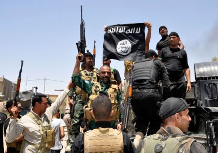 Iraqi security forces pull down a flag belonging to Sunni militant group Islamic State of Iraq and the Levant (ISIL) during a patrol in the town of Dalli Abbas in Diyala province, June 30, 2014. The leader of the al Qaeda offshoot now calling itself the Islamic State has called on Muslims worldwide to take up arms and flock to the 'caliphate' it has declared on captured Syrian and Iraqi soil. Picture taken June 30, 2014.