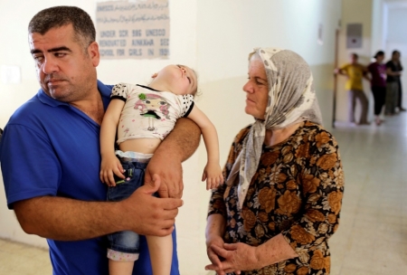 Iraqi Christians, who fled the violence in the village of Qaraqosh, seek refuge inside a church building in Arbil, north of Baghdad, August 11, 2014. Iraqi Christian families sought sanctuary in the church after fleeing towns and villages to escape the advance of Islamic State militants.