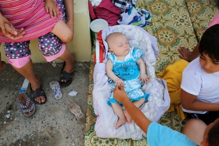 A Christian baby, who fled with his family from the violence in Mosul sleeps at a school in Arbil, in Iraq's Kurdistan region June 27, 2014. Iraqi forces launched an airborne assault on rebel-held Tikrit on Thursday with commandos flown into a stadium in helicopters, at least one of which crashed after taking fire from insurgents who have seized northern cities.