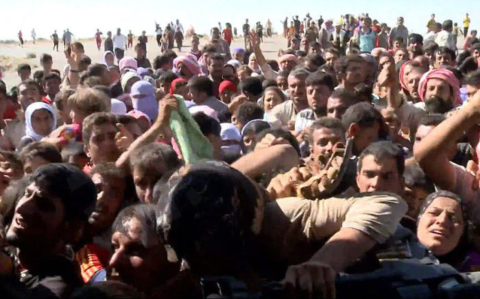 Yazidis in northern Iraq storm an helicopter delivering aid in a desperate bid to escape starvation and persecution at the hand of the Islamic State, or ISIS.