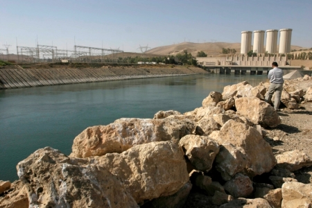 A man stands on the banks of the Mosul Dam on the Tigris River in Mosul, 390 km (240 miles) northwest of Baghdad, Nov. 1, 2007. A million U.S. project has not improved Iraq's largest dam, which is in danger of failing and potentially killing thousands, according to the U.S. inspector for Iraq reconstruction.