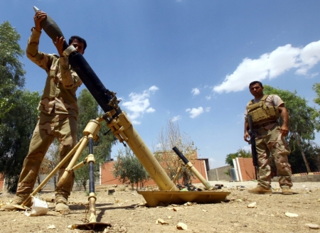 Kurdish 'peshmerga' troops prepare to fire a mortar during an intensive security deployment against Islamic State militants on the outskirts of the province of Nineveh, Aug. 6, 2014. Islamic State militants extended their gains in northern Iraq on Thursday, seizing three more towns and gaining a foothold near the Kurdish region, witnesses said. The advance came after the Sunni militants inflicted a humiliating defeat on Kurdish forces in a weekend sweep in the north. The Islamic State, which has declared a caliphate in parts of Iraq and Syria it controls, clashed with Kurdish forces on Wednesday in the town of Makhmur near Arbil, the capital of the Kurdish semi-autonomous zone.