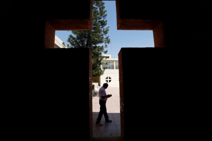 An Iraqi Christian man from Mosul, who fled from violence in their country, reads a book at the Latin Patriarchate Church in Amman, Jordan, Aug. 21, 2014. Hundreds of thousands of Iraqis have fled their homes since the terrorist Islamic State group swept through much of the north and west of Iraq in June, threatening to break up the country.