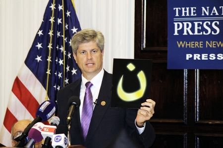 Speaking at the In Defense of Christians Press Conference at the National Press Club in Washington, D.C., U.S. Rep. Jeff Fortenberry holds up the Arabic letter 'N' pronounced 'noon' which stands for the word Nazarenes, which is used as a Arabic derogatory term for Christians. Islamic State forces have been spray painting the letter in 'blood red' marking the homes or businesses of Christians in Mosul, Iraq.