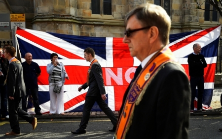 Loyalists march past a Union flag during a pro-Union rally in Edinburgh, Scotland, Sept. 13, 2014. About 12,000 Protestant loyalists from Northern Ireland and Scotland marched through central Edinburgh on Saturday in an emotional show of support for keeping Scotland in the United Kingdom. The referendum on Scottish independence will take place on September 18, when Scotland will vote whether or not to end the 307-year-old union with the rest of the United Kingdom.