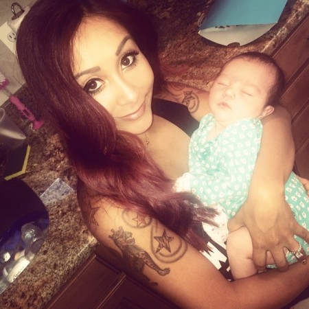 Snooki cradles her goddaughter Meilani (the daughter of Jenni 'JWoww' Farley)