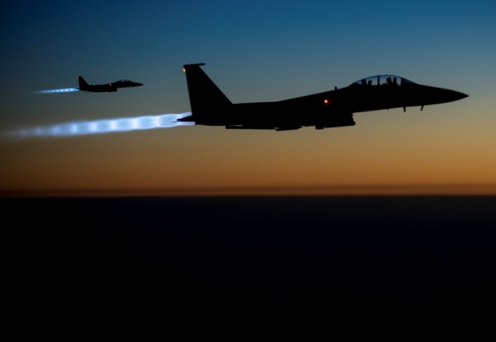 A pair of U.S. Air Force F-15E Strike Eagles fly over northern Iraq after conducting airstrikes in Syria, in this U.S. Air Force handout photo taken early in the morning of September 23, 2014. At least 14 Islamic State fighters were killed in air strikes by U.S.-led forces overnight in northeast Syria, a group monitoring the war said on September 25, 2014, and the Syrian air force bombed rebel areas in the west of the country.