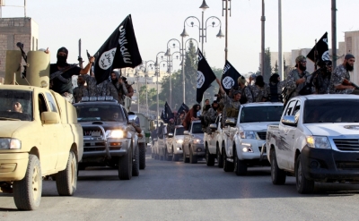 Militant Islamist fighters parade on military vehicles along the streets of northern Raqqa province, Syria, June 30, 2014. Militant Islamist fighters held a parade in Syria's northern Raqqa province to celebrate their declaration of an Islamic 'caliphate' after the group captured territory in neighboring Iraq, a monitoring service said. The Islamic State, an al-Qaida offshoot previously known as Islamic State in Iraq and the Levant.