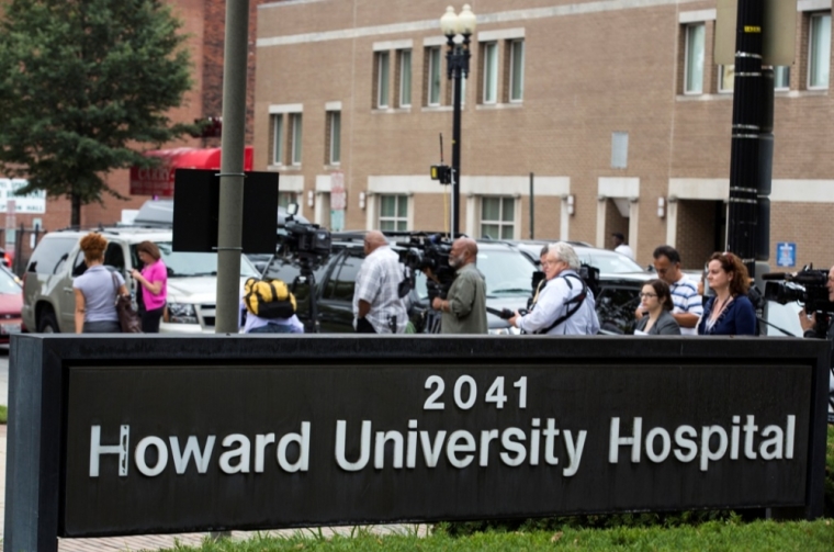 Members of the media stand in front of Howard University Hospital in Washington, October 3, 2014. Howard University Hospital has admitted a patient with possible symptoms of the deadly Ebola virus 'in an abundance of caution,' it said in a statement on Friday. The patient, who had recently traveled to Nigeria, is in stable condition and is being treated in isolation, a hospital spokeswoman said, adding that she could not provide additional details about the case because of patient privacy.