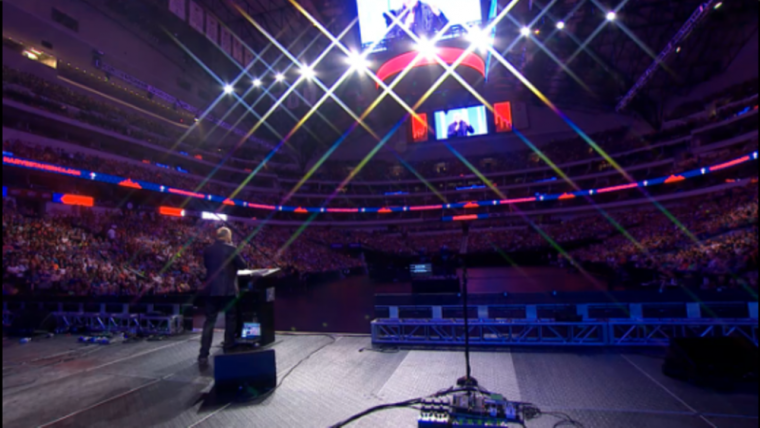 Greg Laurie, senior pastor of Harvest Christian Fellowship in Riverside, California and Harvest Orange County in Irvine, California, shares the Gospel with a sold-out crowd of 19,000 for Harvest America at the American Airlines Center and Victory Park in Dallas, Texas, Oct. 5, 2014.