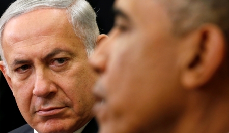 Israel's Prime Minister Benjamin Netanyahu listens as U.S. President Barack Obama (R) speaks, during their meeting in the Oval Office of the White House in Washington, October 1, 2014.