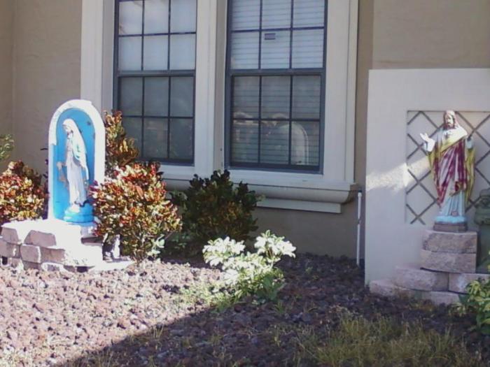 Statues of Jesus Christ and the Virgin Mary, placed in the front yard of the Berluche family of Kissimmee, Florida.