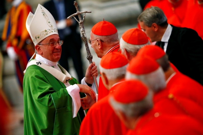 Pope Francis greets a cardinal as he leaves at the end of a mass to mark the opening of the synod on the family in Saint Peter's Square at the Vatican, Rome, Italy, October 5, 2014.