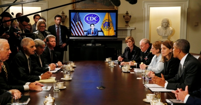 Director of the U.S. Centers for Disease Control and Prevention Tom Frieden, listens via video conference as U.S. President Barack Obama (R) holds a meeting with cabinet agencies coordinating the government's Ebola response in the Cabinet Room of the White House in Washington, October 15, 2014. Obama cancelled a fund raising trip today to hold the meeting.