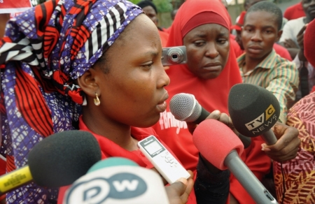 Isaac Rebecca, one of the girls that escaped from the Boko Haram camp, speaks during a protest, in continuation of the Global Week of Action to commemorate six months since the abduction of the 219 Chibok school girls, organized by the Abuja 'Bring Back Our Girls protest group to the Presidential Villa, in Abuja, Nigeria, October 14, 2014.