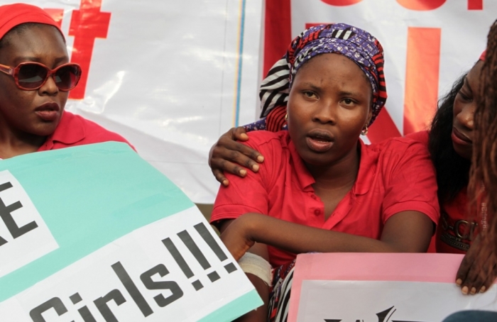 saac Rebecca, one of the girls that escaped from the Boko Haram camp, is comforted during a protest march, in continuation of the Global Week of Action to commemorate six months since the abduction of the 219 Chibok school girls, organized by the Abuja 'Bring Back Our Girls' protest group to the Presidential Villa, in Abuja, Nigeria, October 14, 2014.