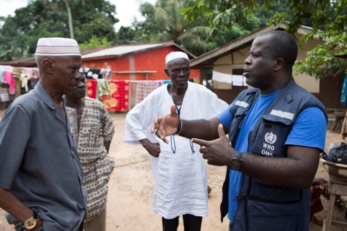 Kande-Bure Kamara from WHO has a discussion with community leaders in Kamasondo Village at Port Loko District October 8, 2014. More than 4,000 people have died of the viral haemorrhagic fever in West Africa, mostly in Liberia, neighbouring Sierra Leone and Guinea. Picture taken October 8, 2014.