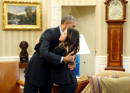 U.S. President Barack Obama hugs Dallas nurse Nina Pham at the Oval Office in Washington, October 24, 2014. Obama gave a big hug on Friday to Nina Pham, the Dallas nurse who survived a bout with Ebola. Obama met Pham in the Oval Office shortly after her release from a nearby hospital after recovering from the virus. Pham contracted the virus while treating Liberian national Thomas Eric Duncan who traveled to the U.S. after having direct contact with a young woman who died from Ebola. Duncan later died of Ebola in a Dallas hospital. Pham had been undergoing treatment at the National Institutes of Health in Bethesda, Maryland, since Oct. 16.