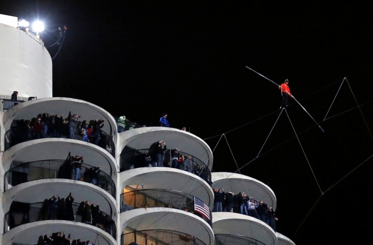 Daredevil Nik Wallenda performs his blindfolded walk along a tightrope between two skyscrapers suspended 500 feet (152.4 meters) above the Chicago River in Chicago, Illinois, November 2, 2014.