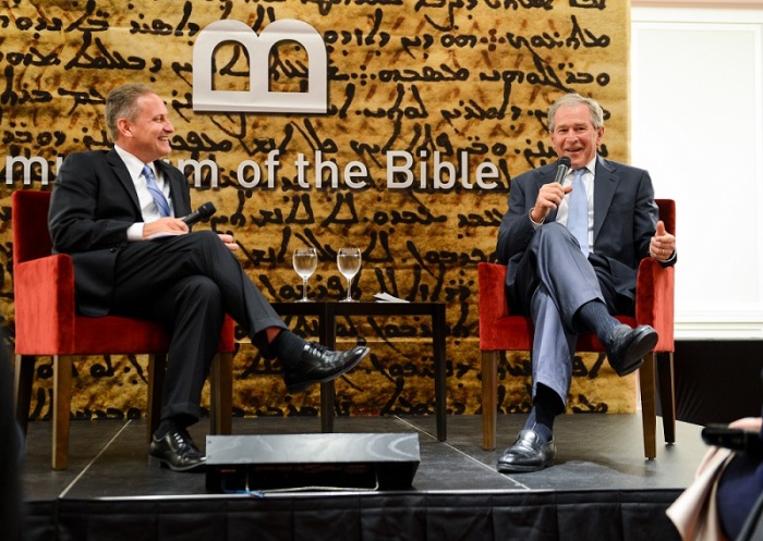 Hobby Lobby President Steve Green (L) talks with former United States President George W. Bush (R) at the presidential library and museum in Dallas, Texas, on Sunday, November 2, 2014, at an event held to spotlight the soon to be built Museum of the Bible in Washington, D.C.