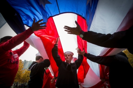 Sea Cadet Connor McDonald participates in the unfurling of an American Flag at the 9/11 Memorial in New York, November 9, 2014. The flag ceremony was part of the 9/11 Memorial's Salute to Service, a five day tribute to veterans for Veterans Day.